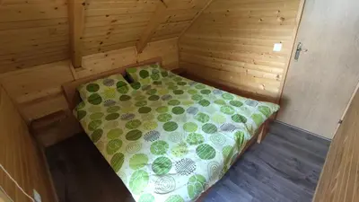 a room with a bed in a wooden cabin at Brvnara Gold Hill in Prijedor