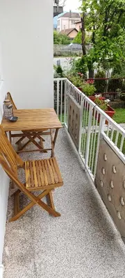 a wooden table and a bench on a balcony at Apartman Bihać SviMi in Bihać
