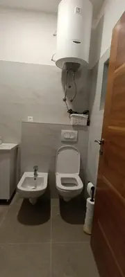 a small bathroom with a toilet and a sink at Apartman Bihać SviMi in Bihać