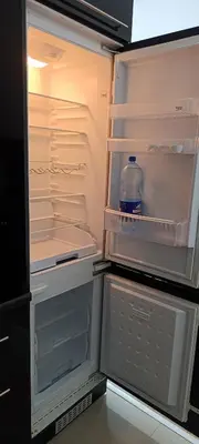 an open refrigerator with a bottle of water in it at Apartman Bihać SviMi in Bihać