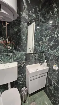 a bathroom with a sink and a toilet and a mirror at Vila Mir in Banja Vrućica