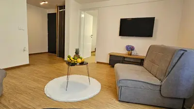 a living room with a couch and a table with fruit on it at Vila Mir in Banja Vrućica