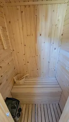 a small wooden sauna with a basket in it at Vila Mir in Banja Vrućica