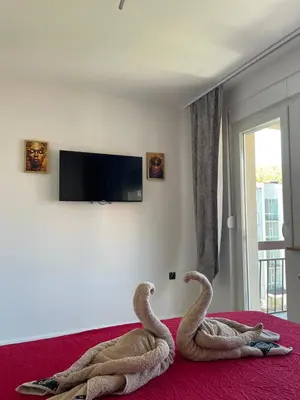 two snakes sitting on a bed in a room at Apartman Lana in Teslić