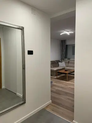 a mirror on a wall in a living room at Apartman Lana in Teslić