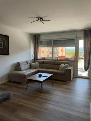 a living room with a couch and a table at Apartman Lana in Teslić