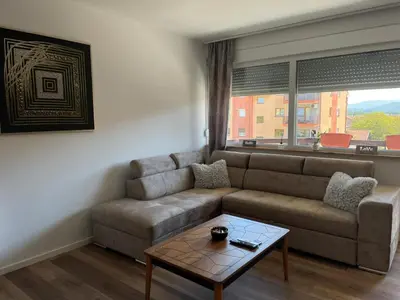 a living room with a couch and a coffee table at Apartman Lana in Teslić