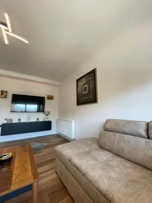 a living room with a couch and a table at Apartman Lana in Teslić