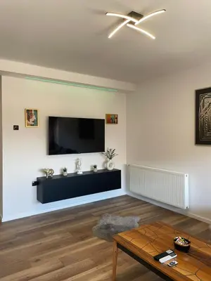a living room with a flat screen tv on the wall at Apartman Lana in Teslić