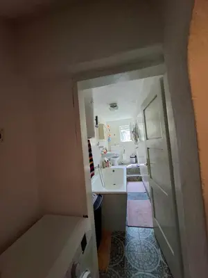 a small kitchen with a sink and a counter at Retro Retreat Izačić in Bihać