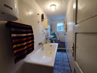 a bathroom with a tub and a sink and a toilet at Retro Retreat Izačić in Bihać