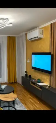 a living room with a flat screen tv on a wall at HeraLux in Doboj