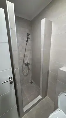 a shower stall in a bathroom with a toilet at HeraLux in Doboj