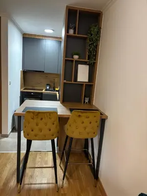 a kitchen with a table and two chairs at HeraLux in Doboj