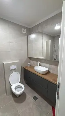 a bathroom with a white toilet and a sink at HeraLux in Doboj