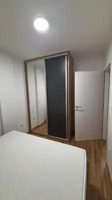 a room with a bed and a large mirror at HeraLux in Doboj