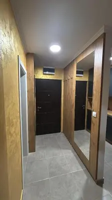 a hallway with black doors and a mirror at HeraLux in Doboj