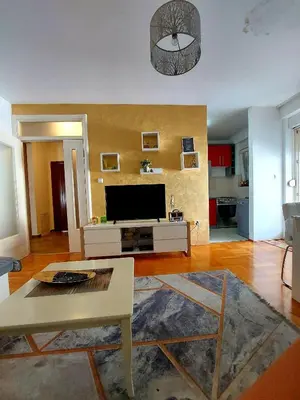 a living room with a tv and a table at Apt Iva 2 in Banja Luka