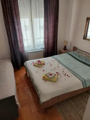 a bedroom with a bed with some confetti on it at Apt Iva 2 in Banja Luka