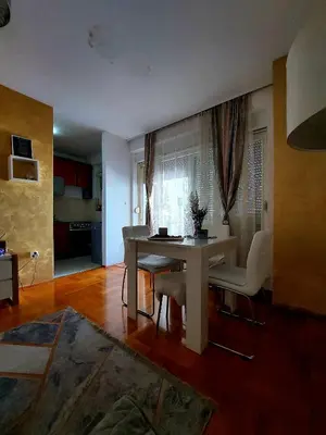 a living room with a dining room table and chairs at Apt Iva 2 in Banja Luka
