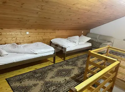 a room with two beds and a staircase in it at Vila Ponijeri in Kakanj
