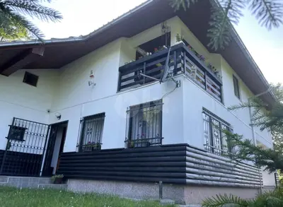 a white house with stairs and a balcony at Vila Ponijeri in Kakanj