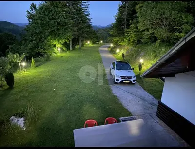 a white car parked on the side of a road at Vila Ponijeri in Kakanj