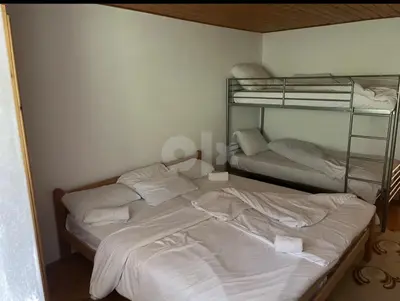 a bedroom with two bunk beds with white sheets at Vila Ponijeri in Kakanj
