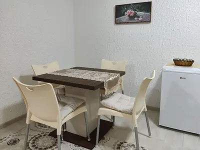 a dining room table with chairs and a table at Vista in Živinice