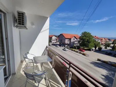 a balcony with two chairs and a view of a street at Vista in Živinice