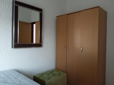 a bedroom with a cabinet and a mirror at Vista in Živinice