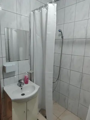 a bathroom with a shower curtain and a sink at Vista in Živinice