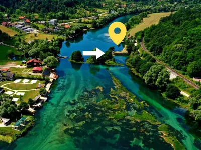 an aerial view of a river with a house and a map at Holiday Homes Mujo Bejzin in Račić