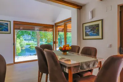 a dining room with a table and chairs at Holiday Homes Mujo Bejzin in Račić