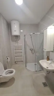 a bathroom with a shower and a toilet and a sink at Apartman Giro in Banja Luka