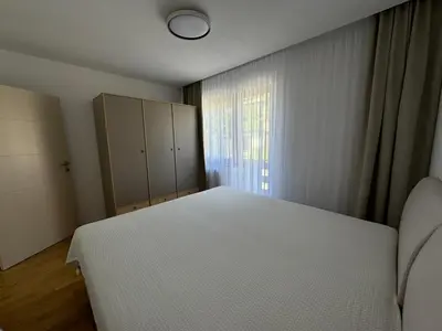 a bedroom with a white bed and a window at Apartmani Bare in Jajce