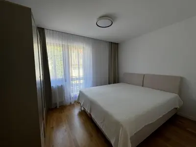 a bedroom with a white bed and a window at Apartmani Bare in Jajce