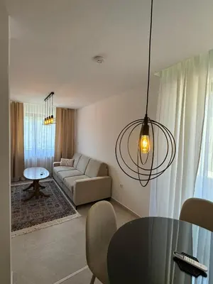 a living room with a couch and a table at Apartmani Bare in Jajce