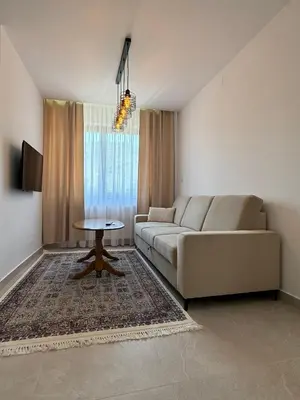 a living room with a couch and a table at Apartmani Bare in Jajce