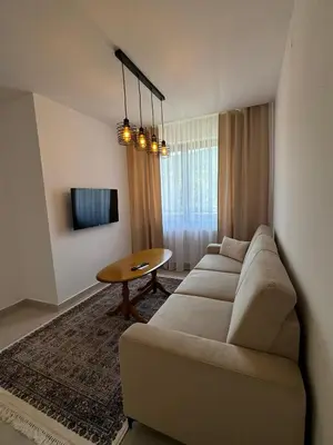 a living room with a couch and a table at Apartmani Bare in Jajce