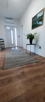 a living room with a potted plant on a table at Apartments White House Bihac in Bihać