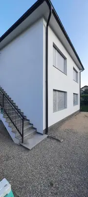 a white building with a staircase next to it at Apartments White House Bihac in Bihać