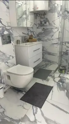 a white bathroom with a toilet and a sink at Apartman Magi in Jajce