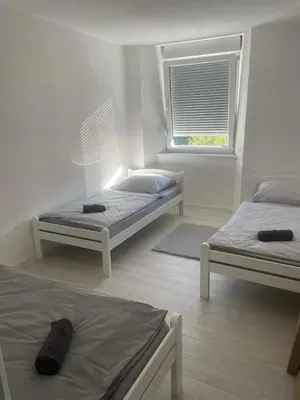 a room with two beds and a window at Apartman Magi in Jajce
