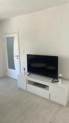 a white entertainment center with a flat screen tv on it at Apartman Magi in Jajce