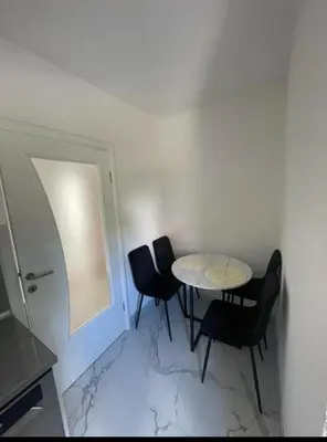 a dining room with a table and two chairs at Apartman Magi in Jajce