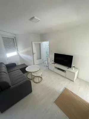 a living room with a couch and a tv at Apartman Magi in Jajce