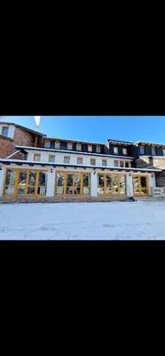 a large white building with many windows on it at Winter Forest Vlasic in Šišava