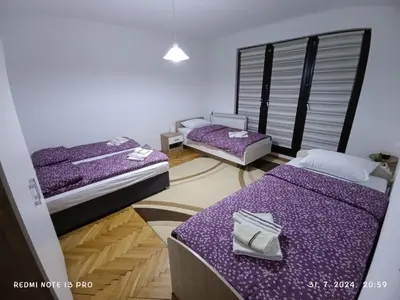 two beds in a room with purple sheets at Apartment Happy Corner in Visoko