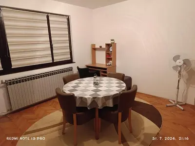 a room with a table and chairs and a window at Apartment Happy Corner in Visoko